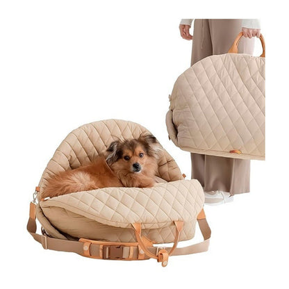 Dog lying in the cream quilted 3-in-1 pet carrier beside a person holding a second carrier