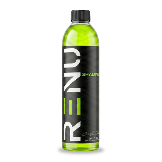Bottle of REN shampoo with green liquid on a white background