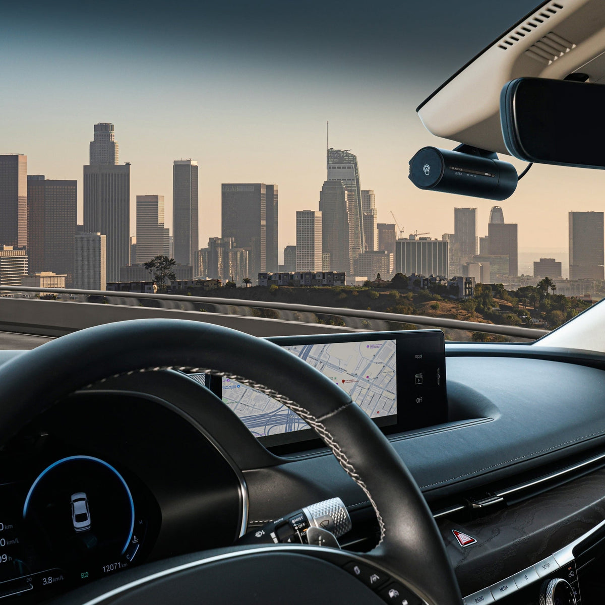 Driver's view of a BlackVue ELITE dash cam behind the rearview mirror