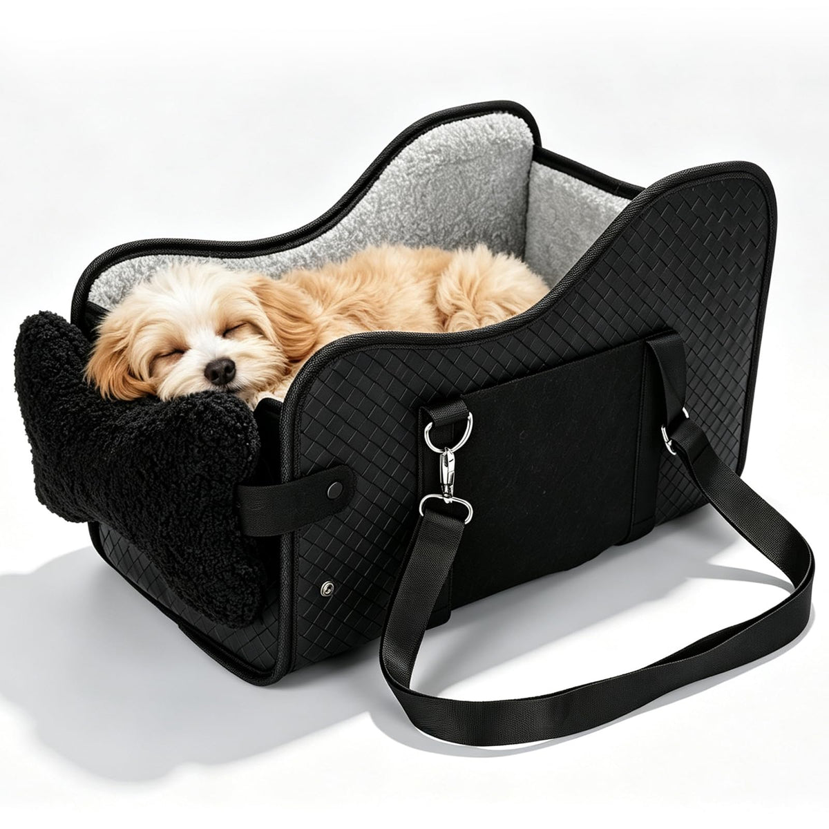 Puppy sleeping in the black console dog car seat, studio view