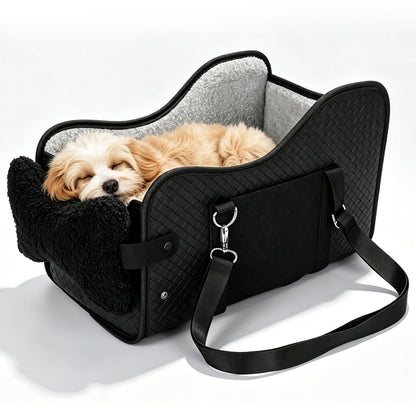 Puppy sleeping in the black console dog car seat, studio view