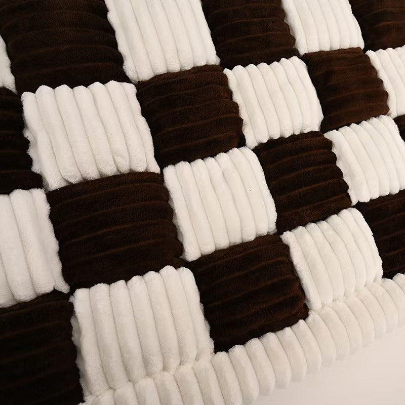 Close-up of the thick ribbed plush in brown and cream checks
