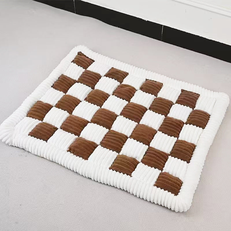 Brown and cream checkered plush dog mat lying flat on a floor