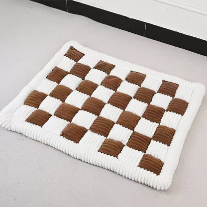 Brown and cream checkered plush dog mat lying flat on a floor