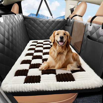Golden retriever lying on the brown checkered plush mat on a car back seat