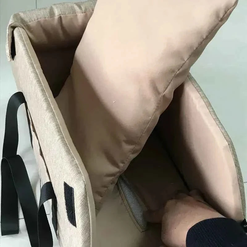Close-up of a beige backpack with a hand reaching inside, on a light gray background