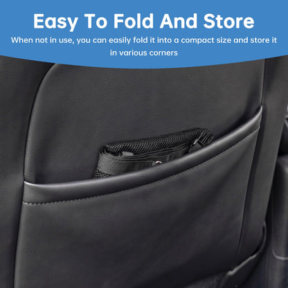 Mesh dog barrier folded into a seat-back pocket for storage