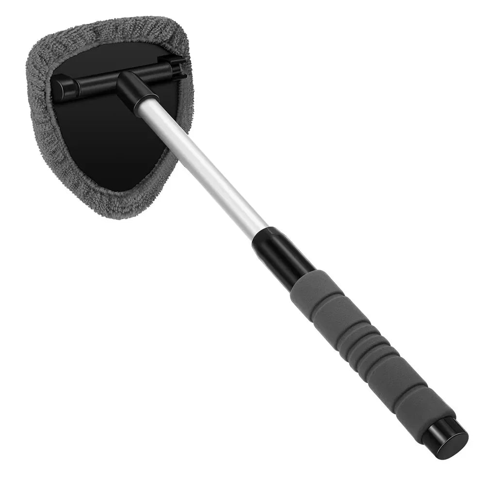 Car wash brush with gray bristle head and black handle on a white background