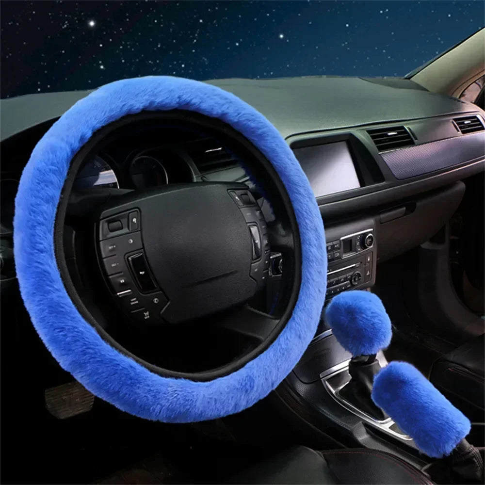 Blue fuzzy steering wheel cover and gear shift cover on a car dashboard.