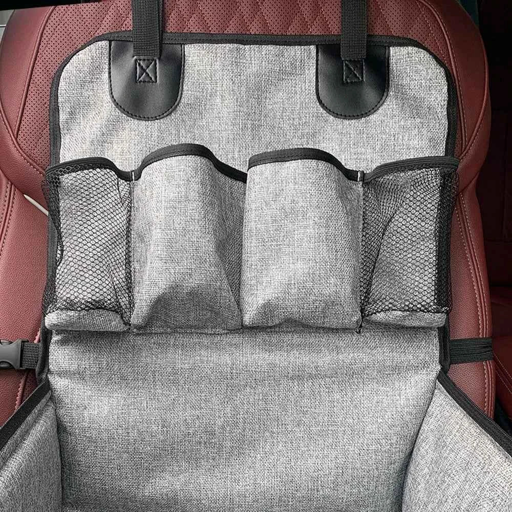 Gray car seat organizer with multiple pockets on a red car seat.