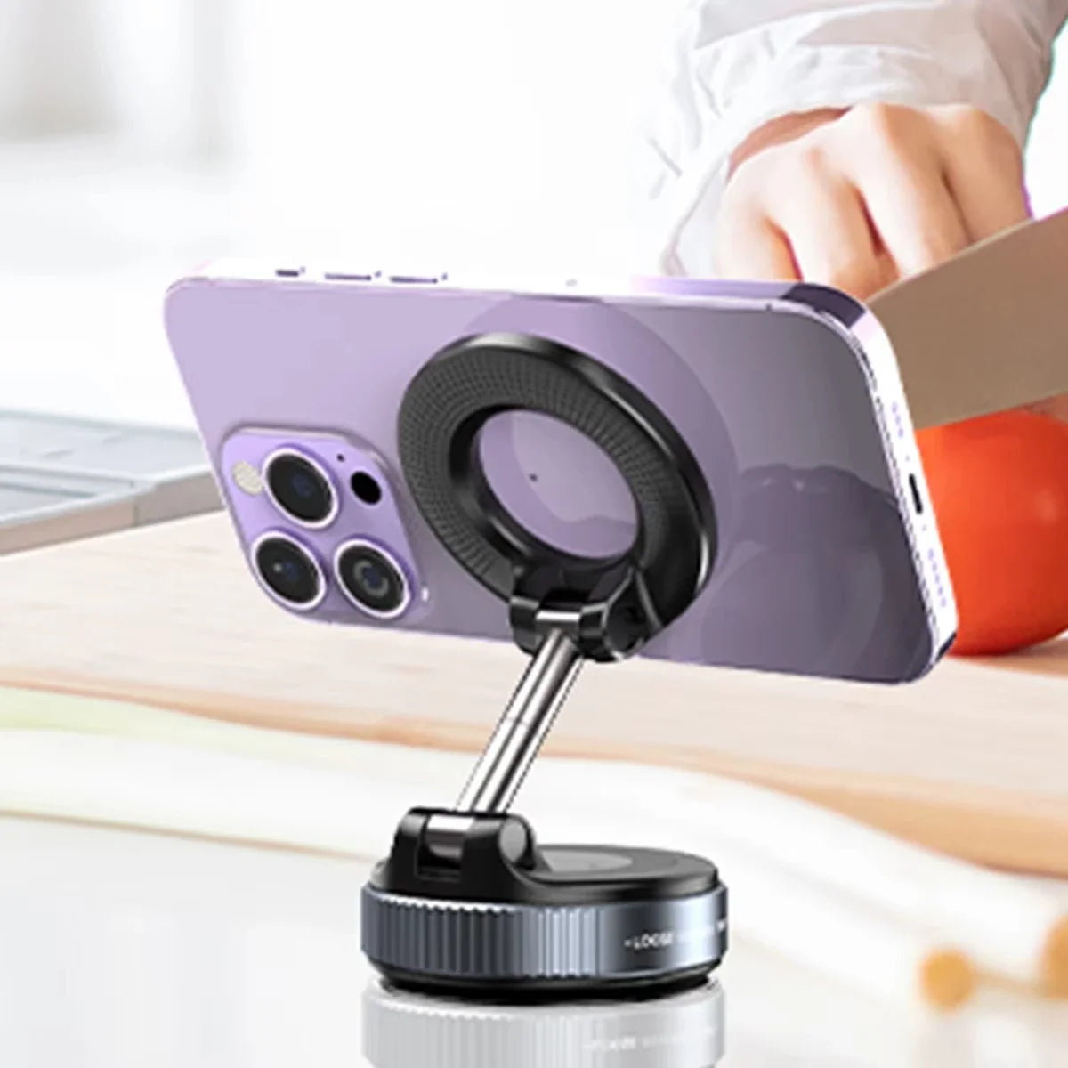 Smartphone with a ring light attachment on a stand, held by a person.