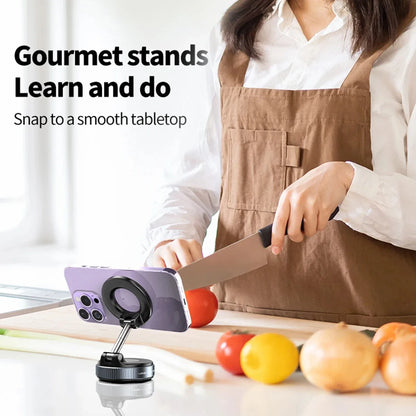 Person in a kitchen using a smartphone stand with text 'Gourmet stands Learn and do Snap to a smooth tabletop'.