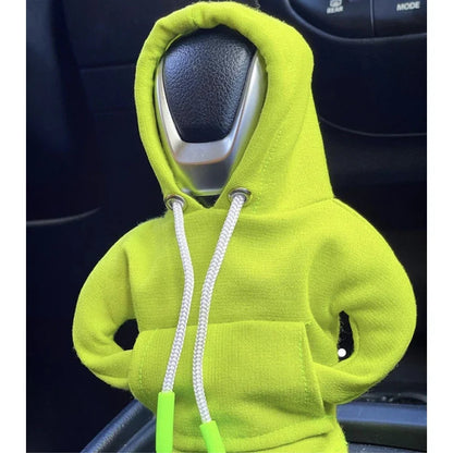 Person wearing a bright green hoodie inside a vehicle.
