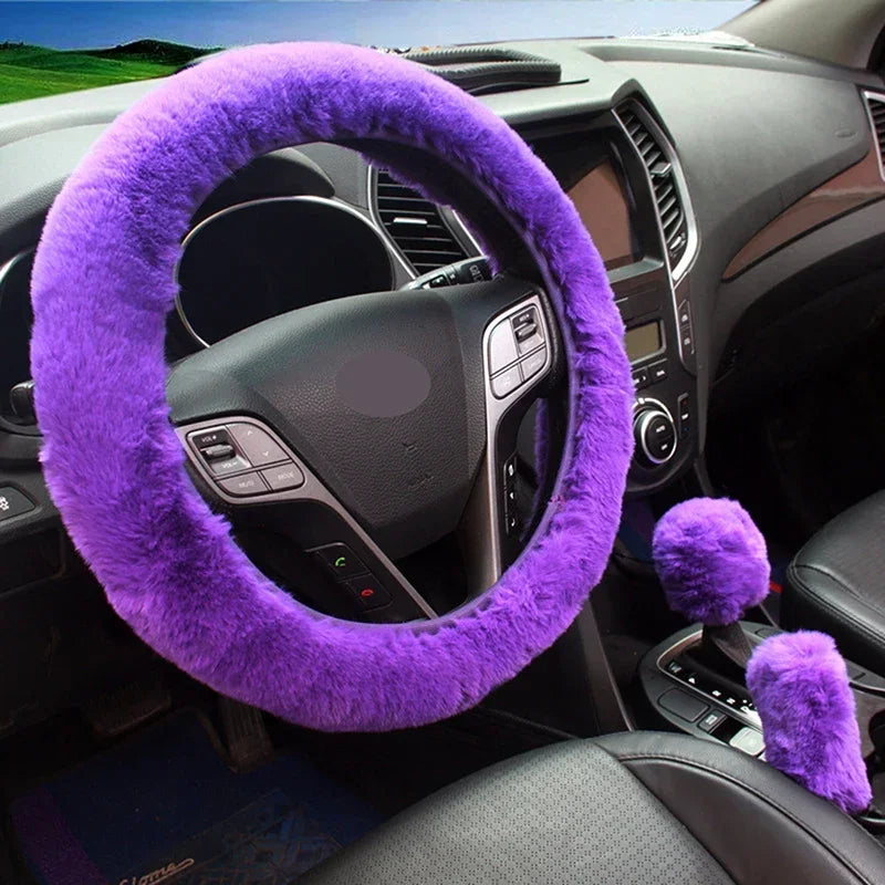 Purple fuzzy steering wheel cover and gear shift cover on a car dashboard.
